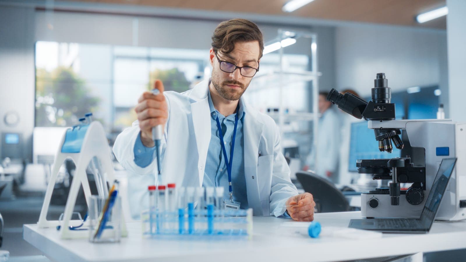 Researcher pipetting peptide samples during synthesis